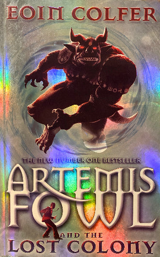 Artemis Fowl and the Lost Colony by Eoin Colfer, book cover with red demon with horns in the middle of the cover. Background color is metallic silver.